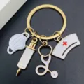 Medical themed metal keychain with nurse cap, syringe, stethoscope and mask charms for gifts. - White Mask Syringe Style (JE1583H)