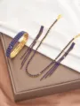 Blue rhinestone gold tone jewelry set detail featuring necklace bracelet and earrings. - Gold Blue Three-Piece Set