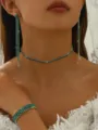 Close-up detail of green rhinestone choker necklace, long earrings and sparkling bracelet set. - Silver Green 3-Piece Set