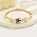Gold tone floral hinge bracelet for women, sparkling blue and clear crystal rhinestones jewelry. - Dark Blue Crystal Floral Style (80512702)