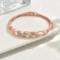 Bracciale rigido geometrico in strass oro rosa, elegante gioiello in cristallo. - Stile Torsione Geometrica (80512236)