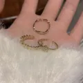 Juego de 3 anillos dorados con diseño de corazón y piedras de circonita brillante, estilo elegante. - Anillo ondulado