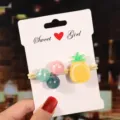 Close-up of cute kids hair tie with pineapple charm and pearl beads on display card detail view - Pineapple Hair Tie