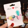 Close-up detail of cute cartoon carrot hair tie with colorful beads and white card display. - Carrot Hair Tie