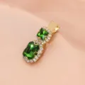 Close-up of the vintage green rhinestone hair clip showing the sparkling crystals and gold. - Double Stone Clip (S34) / Emerald