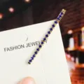 Detailed shot of blue rhinestone hairpin, elegant golden bobby pin on card display. - Straight Hair Clip (6#) / Gold / Royal Blue Zirconia