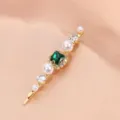 Close-up detail shot of the golden hair clip featuring sparkling green square zircon and pearls. - Rhinestone Pearl Barrette (S34) / Dark Green