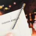 Rhinestone bobby pin detail shot, featuring sparkling blue crystals on a sleek gold-tone metal base. - Straight Inlaid Rhinestone Style (12#) / Blue Rhinestone