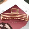 Close-up of a large gold metal hair claw clip with geometric hollow design, ideal for styling. - Large Geometric Hollow Style (S156-4) / 11.3cm