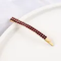 Close-up detail of a double-row red rhinestone hair clip, gold-tone metal side clip accessory. - Curved Double Row Rhinestone Style (13#) / Gold Red Zirconia