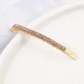 Gold rhinestone bobby pin detail shot, sparkling crystal hair clip, elegant side hair accessory. - Curved Hair Clip / Gold Champagne Stone