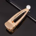 Pince à cheveux en métal doré avec perle blanche élégante, design géométrique tendance chic. - Pince croco en métal perlée pointue 8 cm