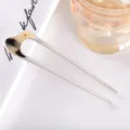 Closeup detail view of a modern minimalist U-shaped acetate hair stick, elegant hair accessory. - 10.9cm / Beige