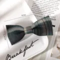 Close up of a green plaid bow hair clip, school style JK hair accessory detail view. - Dark Green