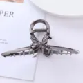 Metal hair claw detail shot, elegant bow design, sturdy grip for daily styling and elegant updos. - Geometric Bow Claw Clip (46#)