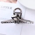 Detail shot of a dark metallic hair claw clip featuring cute double heart ornaments and teeth. - Geometric Heart Claw Clip (45#)