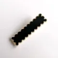 Close-up detail of a stylish black and white acrylic wavy hair clip, chic side pin. - S316 / Floral Edge Black