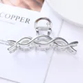 Detailed close-up view of silver metal hair claw clip with elegant cross design for styling. - 13# Silver Double Ring Cross Streamlined Style / Individual Packaging / 10.7cm
