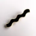 Closeup view of a stylish black and white wave acrylic hair clip detail design accessory. - S316 / Floral Edge Black