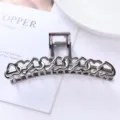 Detailed shot of gunmetal metallic hair claw featuring interlocking openwork heart design. - Hollow Linked Hearts Style (47#)
