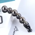 Close-up of minimalist black banana hair clip featuring metallic beads and sparkling rhinestones. - 2# Pearl Rhinestone Banana Clip