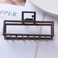 Close-up of the brown matte geometric metal hair claw clip showing hollow frame detail. - Geometric Rectangular Hollow Style (104#)