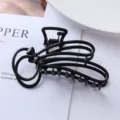 Detailed close-up view of a chic black metal hair claw clip with bowknot for daily hair styling. - Geometric Bow Claw Clip (73#)