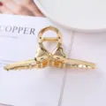 Gold metal hair claw clip with stylish heart bow design, perfect for elegant hair styling. - 20# Gold Heart Bowknot Hollow Style / Individual Packaging / 11.5cm