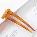 Detailed close-up of the elegant amber acetate bow hair fork, perfect for stylish buns and updos. - Bowknot Hair Fork / Amber