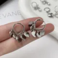 Silver heart hoop earrings detail shot, minimalist chic metal dangle jewelry for women. - Heart Disc Huggie Earrings
