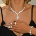 Stunning bridal crystal jewelry set detail showing sparkling necklace, earrings, ring, and bracelet. - Four-Piece Set / White