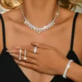 Sparkling silver bridal jewelry set detail featuring crystal necklace earrings and bracelet. - White Four-Piece Set (9186-7)
