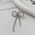 Silver rhinestone bow ear clip detail shot, elegant niche design fashion jewelry piece. - Full Rhinestone Butterfly Clip-On Earring (Single Piece)