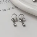 Silver zircon earrings with elegant bow and drop pendant, minimalist chic style for women. - Zirconia Butterfly Stud Earrings (1 Pair)