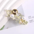 Gold tone metal hair clip featuring faux pearls, rhinestones and a brown central crystal. - Floral Rhinestone Duckbill Clip / Gold