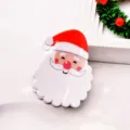 Detailed close-up of a cute Christmas Santa Claus hair claw clip, festive holiday hair accessory. - Smiling Santa Claus