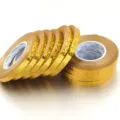 Gold holographic ribbon tape detail shot, perfect for gift wrapping and party balloon decorations. - 10 Rolls/Pack / Gold