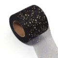 Detail view of black tulle mesh fabric roll with gold foil stars for DIY craft and party decor. - Bronzing Star Black