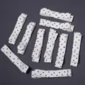 Detail view of white polka dot bow accessories, perfect for DIY crafts and hair clips. - 10 Pieces/Pack / White