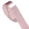 Close-up detail of a rolled pink shiny velvet ribbon for sewing and gift wrapping. - Korean Pink