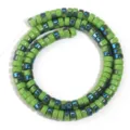 Close-up detail of green electroplated glass wheel spacer beads for DIY jewelry crafting. - Olive Green Luster