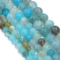 Vista dettagliata di perle rotonde in agata vena di drago blu, ideali per accessori fai da te. - 6mm / Agata a Venatura di Drago Blu Mare