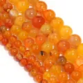 Dettaglio in primo piano di perline tonde in agata vena di drago arancione per gioielli. - 6mm / Agata Vena di Drago Arancione