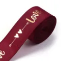 Burgundy polyester ribbon with gold love and heart print, exquisite detail for gift wrapping. - Burgundy