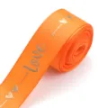 Orange polyester ribbon with gold foil love print, ideal for DIY gift box packaging and bows. - Orange