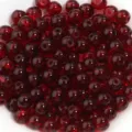Detailed close-up shot of dark red glass round beads, perfect for DIY jewelry making and crafts. - 6mm / 50 Pieces Set / Burgundy