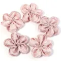 Close-up detail of shiny satin five-petal flower DIY fabric accessories in soft pink color. - 5 Pieces/Pack (6-7cm) / Pink