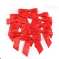 Detailopname van helderrode polyester lintstrikken met draadbinders voor cadeauverpakkingen. - Maat 9X9cm Lintbreedte 2.5cm 16g/Pak / Rood