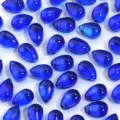 Blue teardrop glass beads close up showing translucent crystal material for DIY jewelry crafting. - 50 Pieces/Pack (9x6mm) / Royal Blue Water Drop