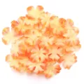 Close-up detail of artificial fabric four-petal flower patches in orange gradient DIY craft. - 60-piece Set / Orange